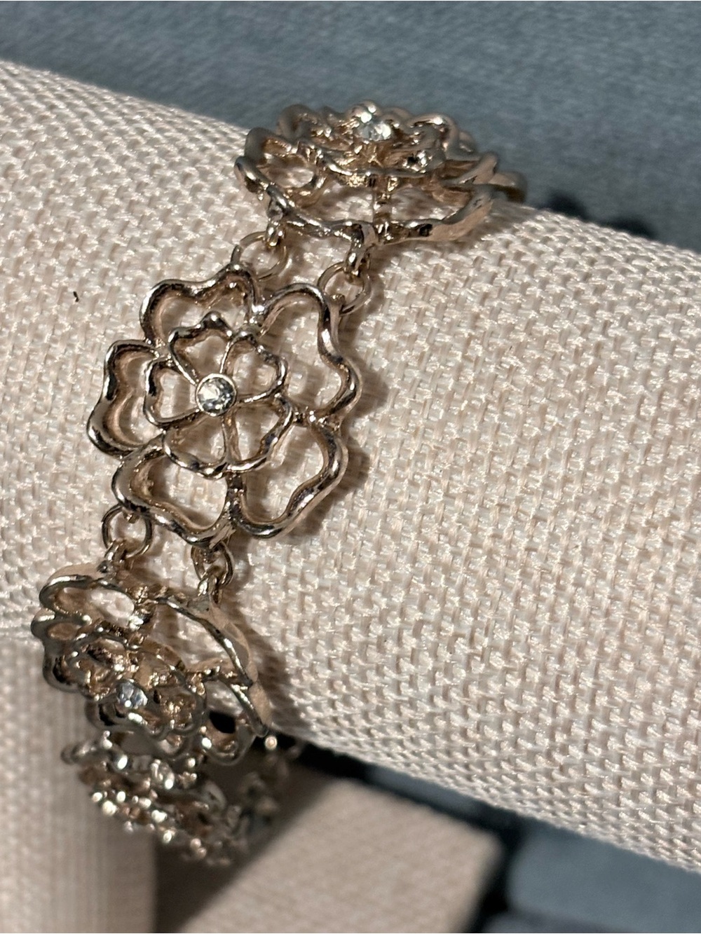 Lovely goldtone openwork rose bracelet with center rhinestone